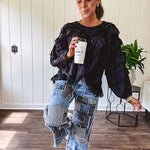 Medium wash denim wide leg pants with washed black, black and white stripe and denim patchwork detail throughout.