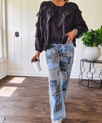Medium wash denim wide leg pants with washed black, black and white stripe and denim patchwork detail throughout.