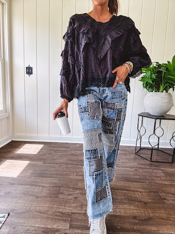 Medium wash denim wide leg pants with washed black, black and white stripe and denim patchwork detail throughout.
