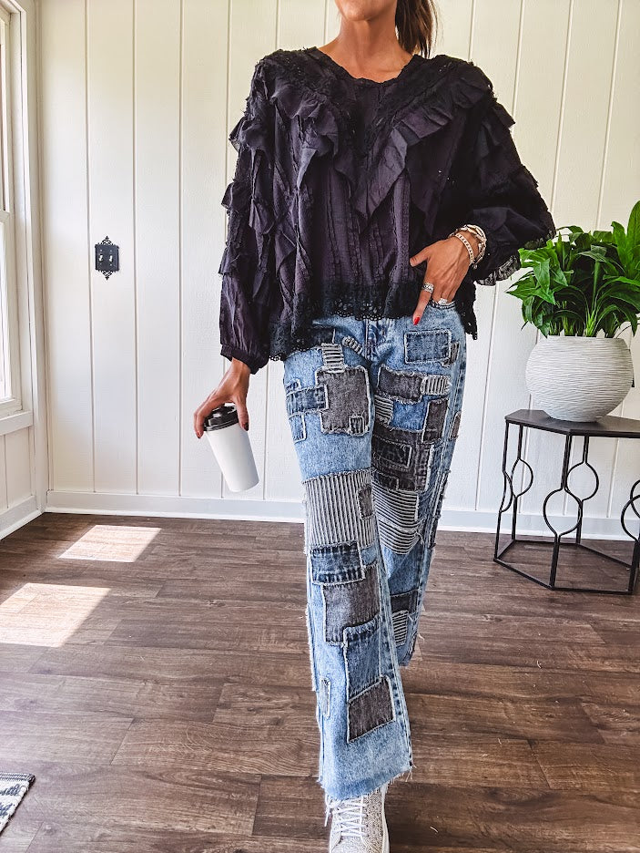 Medium wash denim wide leg pants with washed black, black and white stripe and denim patchwork detail throughout.