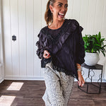 Light wash leopard print elastic waist wide leg pants with frayed hem.