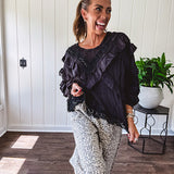 Light wash leopard print elastic waist wide leg pants with frayed hem.