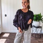 Light wash leopard print elastic waist wide leg pants with frayed hem.