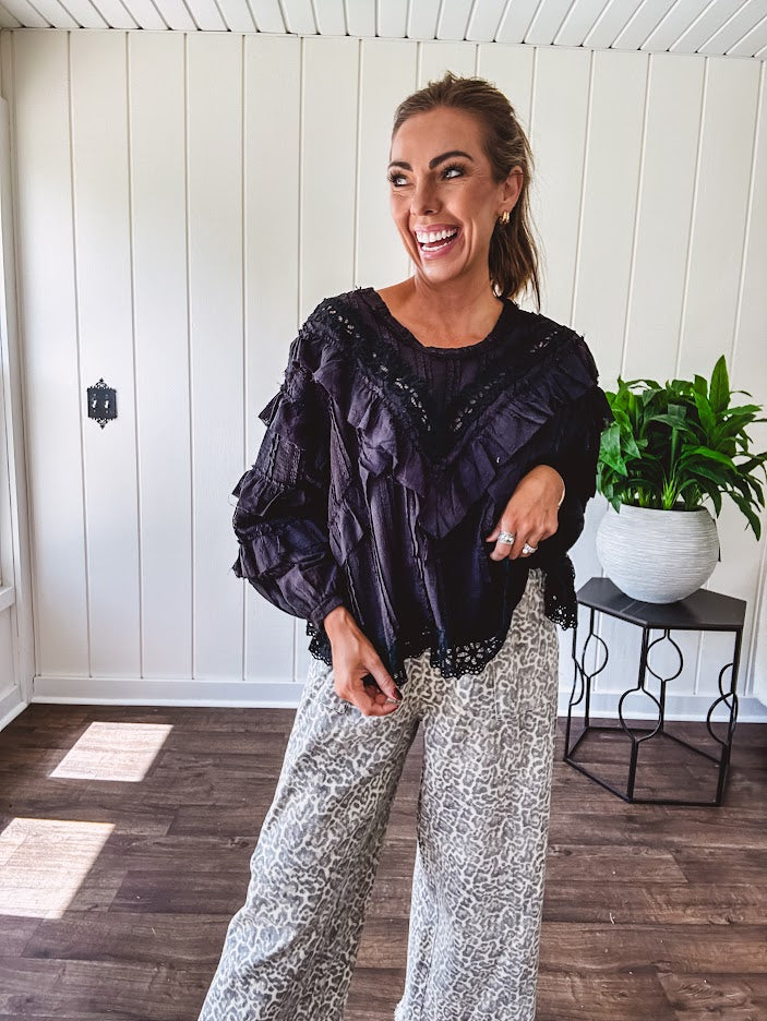 Light wash leopard print elastic waist wide leg pants with frayed hem.