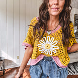 Open weave crochet sweater with 3/4 sleeves and large contrasting crochet flower on the front and contrasting trim. Oversized. Available in multiple colors.