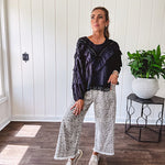 Light wash leopard print elastic waist wide leg pants with frayed hem.