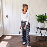 Textured washed black checkered elastic waist fray hem pants with pockets.