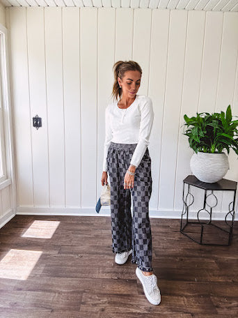 Textured washed black checkered elastic waist fray hem pants with pockets.