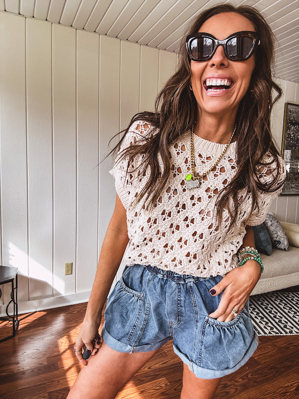 Lightweight, oatmeal open weave crochet sweater with short sleeves.