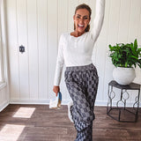 Cozy soft long sleeved ivory fine knit ribbed sweater with four abalone buttons down front.