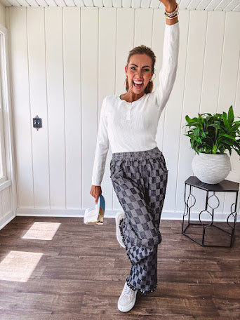 Cozy soft long sleeved ivory fine knit ribbed sweater with four abalone buttons down front.