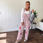 Cream and crimson striped overalls with button adjustable straps and sides with paint splatter and patchwork detail throughout.