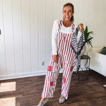 Cream and crimson striped overalls with button adjustable straps and sides with paint splatter and patchwork detail throughout.
