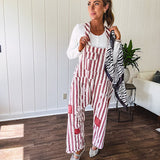 Cream and crimson striped overalls with button adjustable straps and sides with paint splatter and patchwork detail throughout.