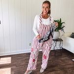 Cream and crimson striped overalls with button adjustable straps and sides with paint splatter and patchwork detail throughout.