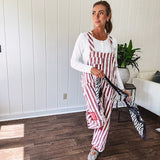 Cream and crimson striped overalls with button adjustable straps and sides with paint splatter and patchwork detail throughout.