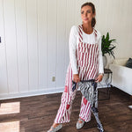 Cream and crimson striped overalls with button adjustable straps and sides with paint splatter and patchwork detail throughout.