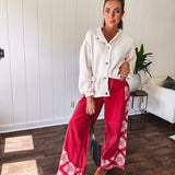 Soft cream snap front cardigan with front pockets and balloon style sleeves with ribbed collar.