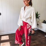 Soft cream snap front cardigan with front pockets and balloon style sleeves with ribbed collar.