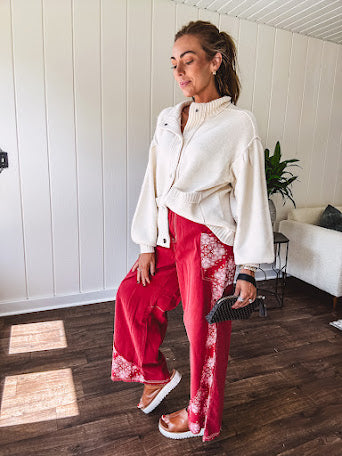 Soft cream snap front cardigan with front pockets and balloon style sleeves with ribbed collar.