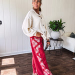 Red cotton wide leg pants with white bandana-style inserts on the outer legs.