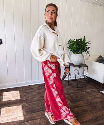 Red cotton wide leg pants with white bandana-style inserts on the outer legs.