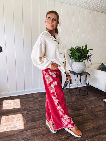 Red cotton wide leg pants with white bandana-style inserts on the outer legs.