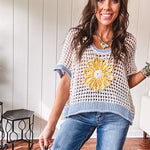 Open weave crochet sweater with 3/4 sleeves and large contrasting crochet flower on the front and contrasting trim. Oversized. Available in multiple colors.