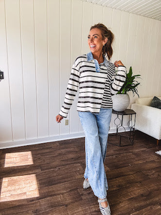 Black and ivory striped asymmetrical hem long sleeved pullover with denim collar and 3 button front.