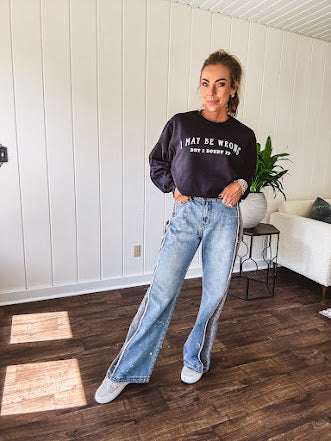 Soft black crewneck sweatshirt with "I May Be Wrong But I Doubt It" graphic on the front.
