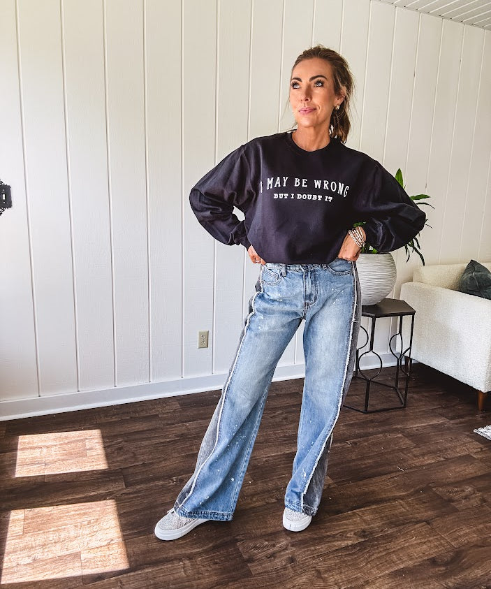 Soft black crewneck sweatshirt with "I May Be Wrong But I Doubt It" graphic on the front.