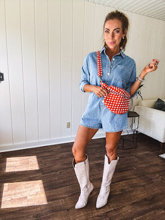 Lightweight light wash denim shorts romper with long sleeves, silver buttons down the front and classic collar with front pocket.