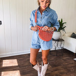 Quilted belt bag featuring zippered pockets and a gingham pattern available in several colors.