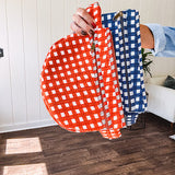 Quilted belt bag featuring zippered pockets and a gingham pattern available in several colors.