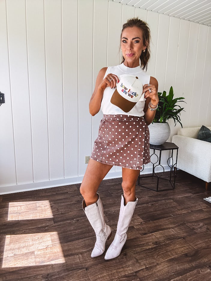 Washed light brown wrap skort with cream polka dots throughout elastic back with back pockets and side 