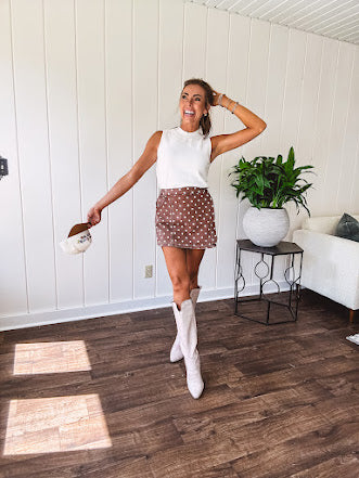 Washed light brown wrap skort with cream polka dots throughout elastic back with back pockets and side pockets.