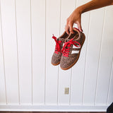 Mini leopard print sneakers with white stripes on the sides and contrasting red laces.