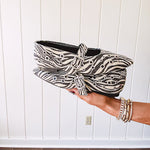Cream and black zebra print ballet flat with pointed tow, Mary Jane style buckle across the top and silver rivet holes throughout.