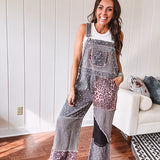 Washed black and pink patchwork jumpsuit with leo and floral print throughout, wide leg design, raw hems, adjustable straps and sides.