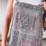 Washed black and pink patchwork jumpsuit with leo and floral print throughout, wide leg design, raw hems, adjustable straps and sides.