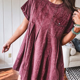 Washed wine mini dress with relaxed, pleated design and pockets, short sleeves.