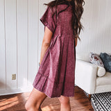 Washed wine mini dress with relaxed, pleated design and pockets, short sleeves.