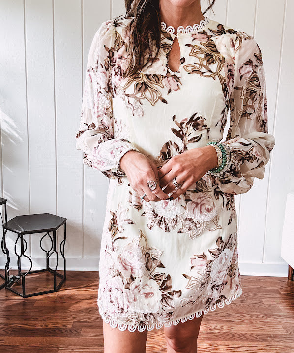 Mini dress in ivory with vintage floral design, fully lined, sheet long sleeves, lace detail at the eyelet neckline and collar and hem. Zip up back.