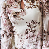 Mini dress in ivory with vintage floral design, fully lined, sheet long sleeves, lace detail at the eyelet neckline and collar and hem. Zip up back.