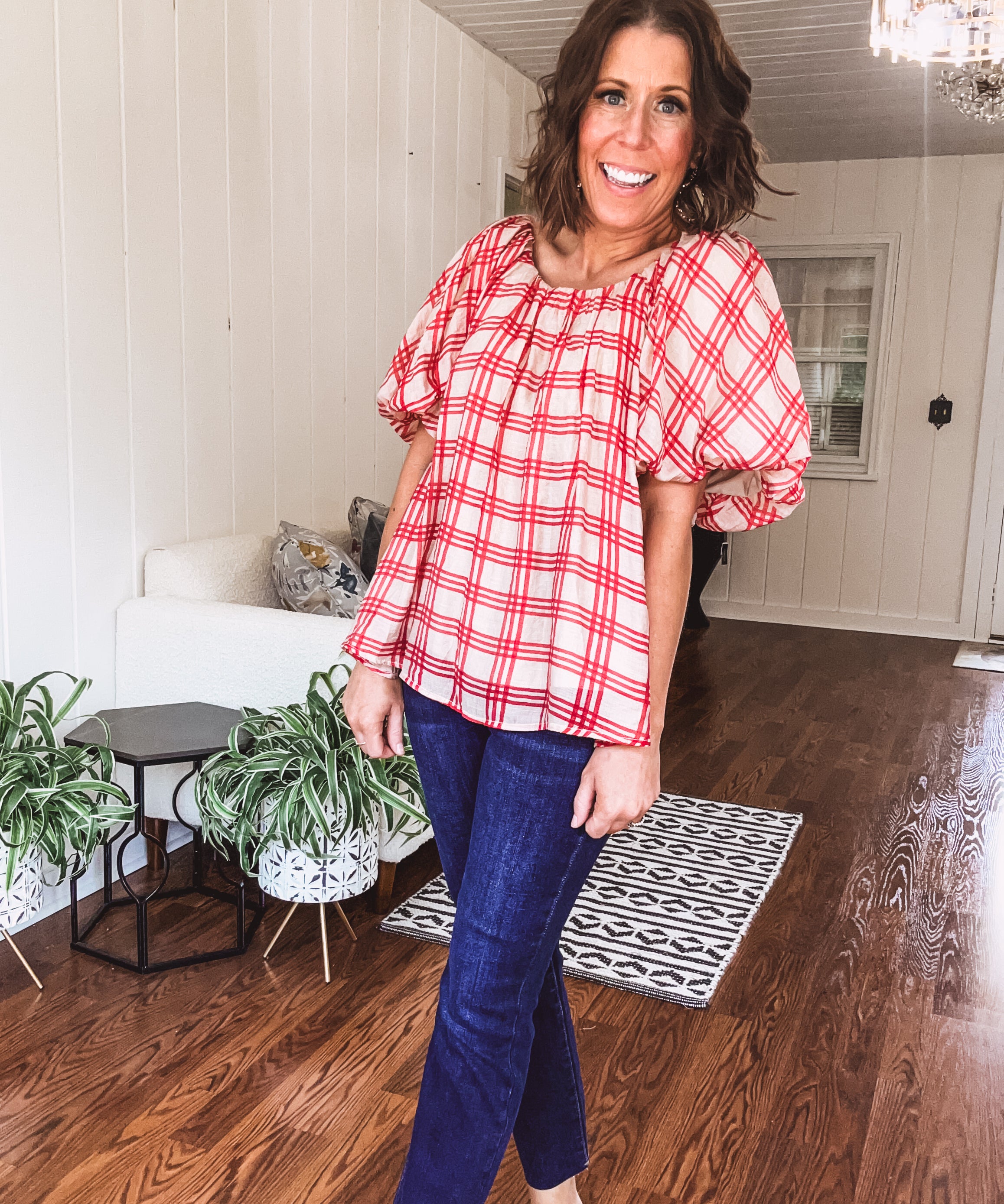 Red and tan windowpane check blouse withp uff sleeve, round neck and flowy hem.