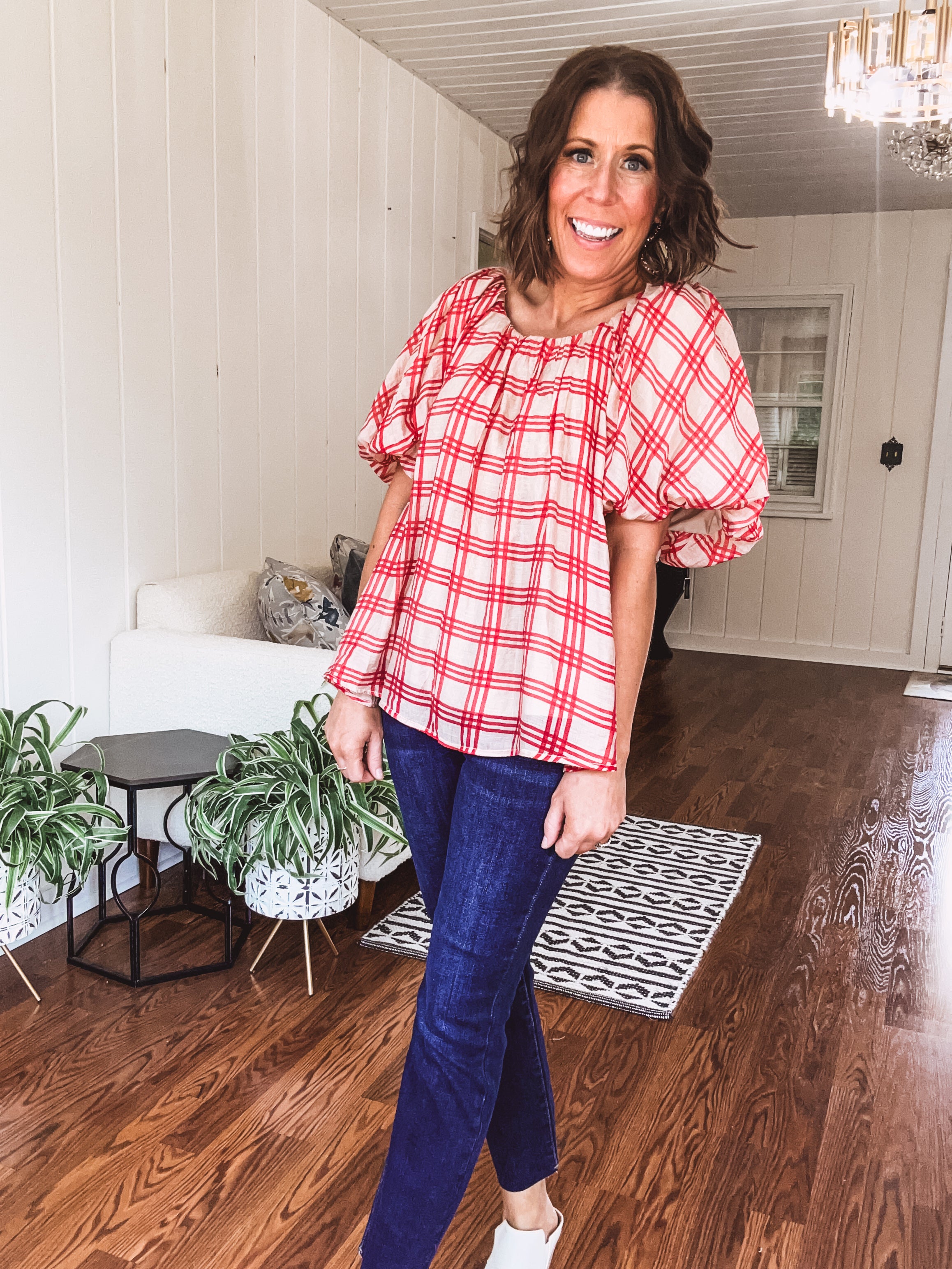 Red and tan windowpane check blouse withp uff sleeve, round neck and flowy hem.