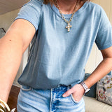 Buttery soft, thin tee with exposed seams and round neck and U shaped hem.