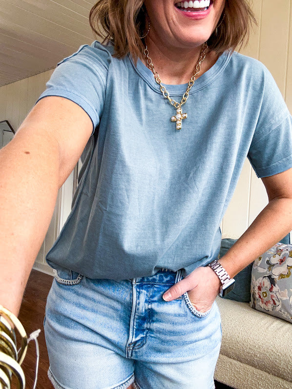 Buttery soft, thin tee with exposed seams and round neck and U shaped hem.