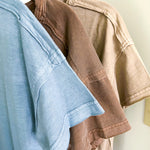 Buttery soft, thin tee with exposed seams and round neck and U shaped hem.