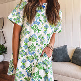 Cream shirt dress with blue and green floral print throughout, contrasting blue trim at the covered placket and hem, cuffed sleeves, mini length, fully lined.